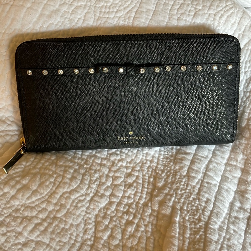 Kate Spade black wallet with rhinestone detail, bow, and gold hardware